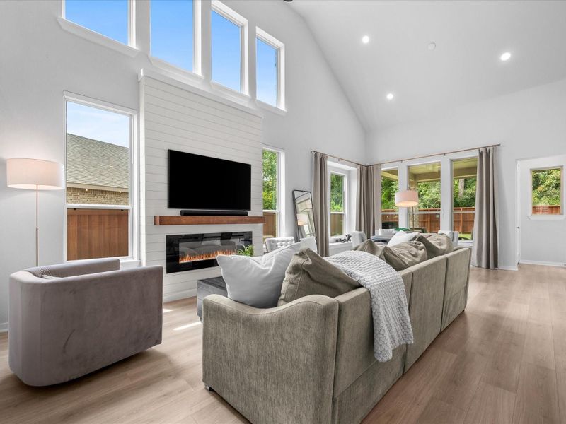 Living/dining combo perfect for easy entertaining. Automatic window shades on windows beside fireplace