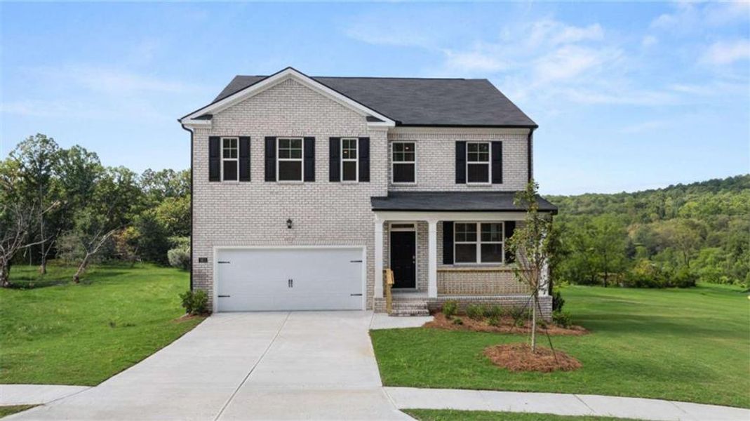 Front exterior of a new home in Bridle Creek, Locust Grove, GA, highlighting curb appeal (Image 1). Front exterior of a new home in Bridle Creek, Locust Grove, GA, highlighting curb appeal (Image 1).