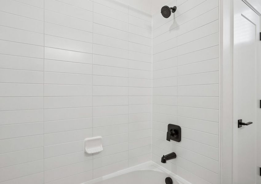 The secondary bathroom has a beautiful shower-tub combo.
