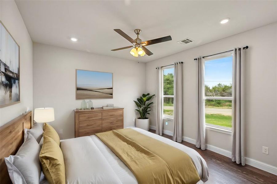 Bedroom featuring ceiling fan and dark hardwood / wood-style flooring