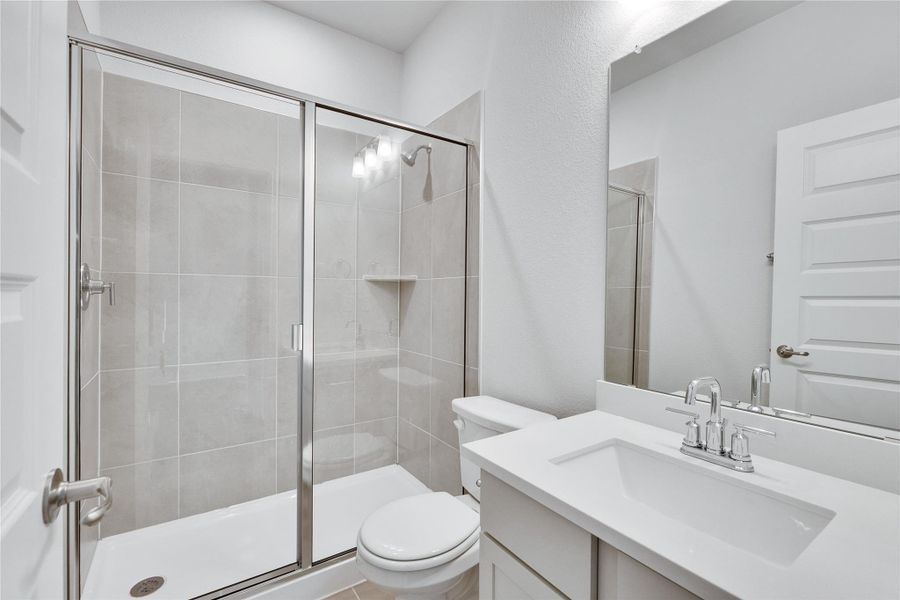 Bathroom featuring a stall shower and vanity Bathroom featuring a stall shower and vanity