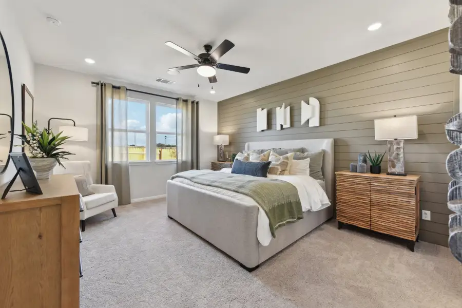 A bedroom with a bed and a fan. A bedroom with a bed and a fan.