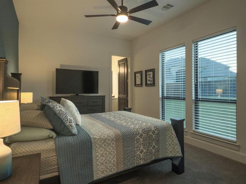 Bedroom featuring carpet floors and ceiling fan Bedroom featuring carpet floors and ceiling fan