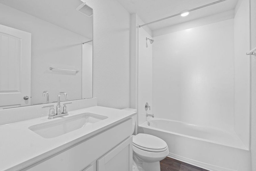 Bathroom with shower combination, dark wood-style flooring, and vanity Bathroom with shower combination, dark wood-style flooring, and vanity