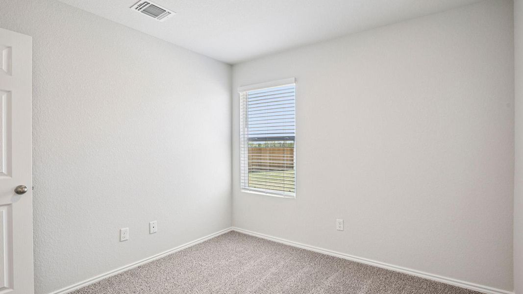 Neutral tone walls with textured finish, light grey carpet flooring, and white trim Neutral tone walls with textured finish, light grey carpet flooring, and white trim