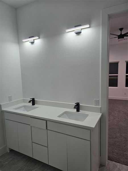 Bathroom featuring vanity and ceiling fan