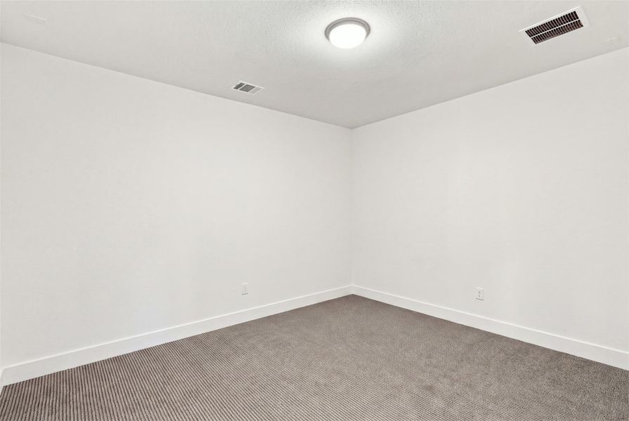 Soft carpeting pairs with neutral walls to create a versatile and quiet interior space.