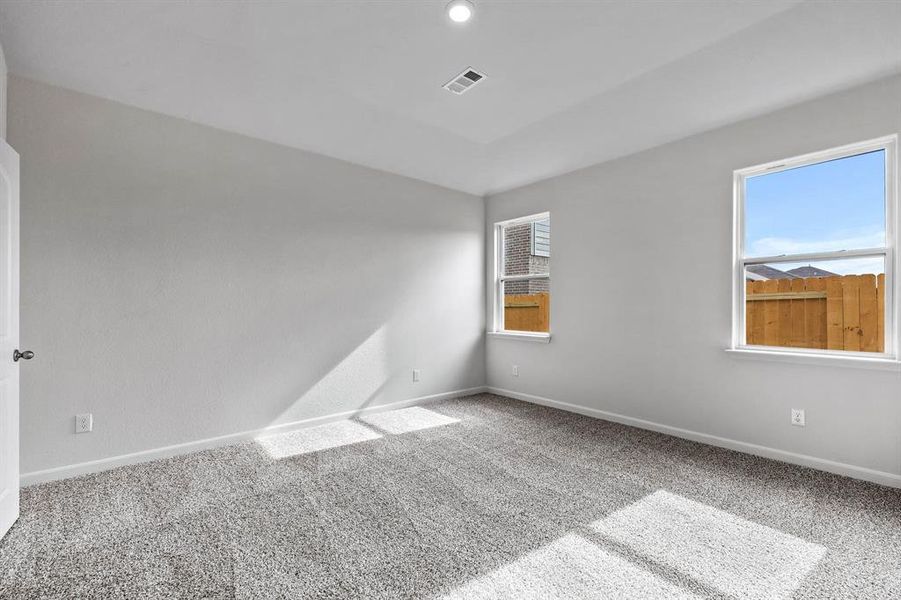 Carpeted empty room with plenty of natural light