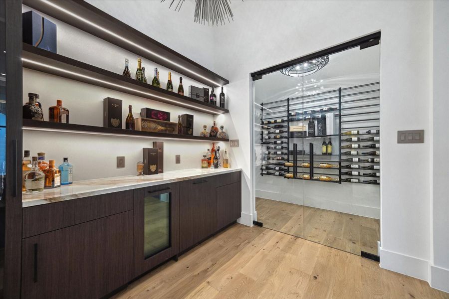 We welcome wine lovers to explore our exquisite glass-encased wine room