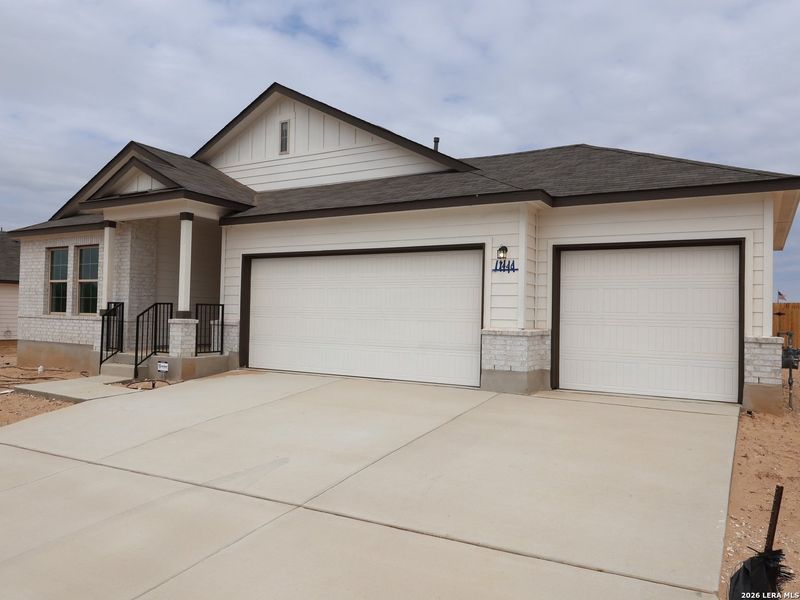 Front exterior of a new home in Hickory Ridge, Elmendorf, TX, highlighting curb appeal (Image 2). Front exterior of a new home in Hickory Ridge, Elmendorf, TX, highlighting curb appeal (Image 2).