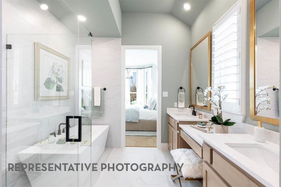 Ensuite bathroom with double vanity, light marble finish flooring, recessed lighting, a shower with door, and a soaking tub