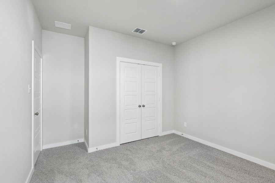 Bedroom in the Oscar home plan by Trophy Signature Homes