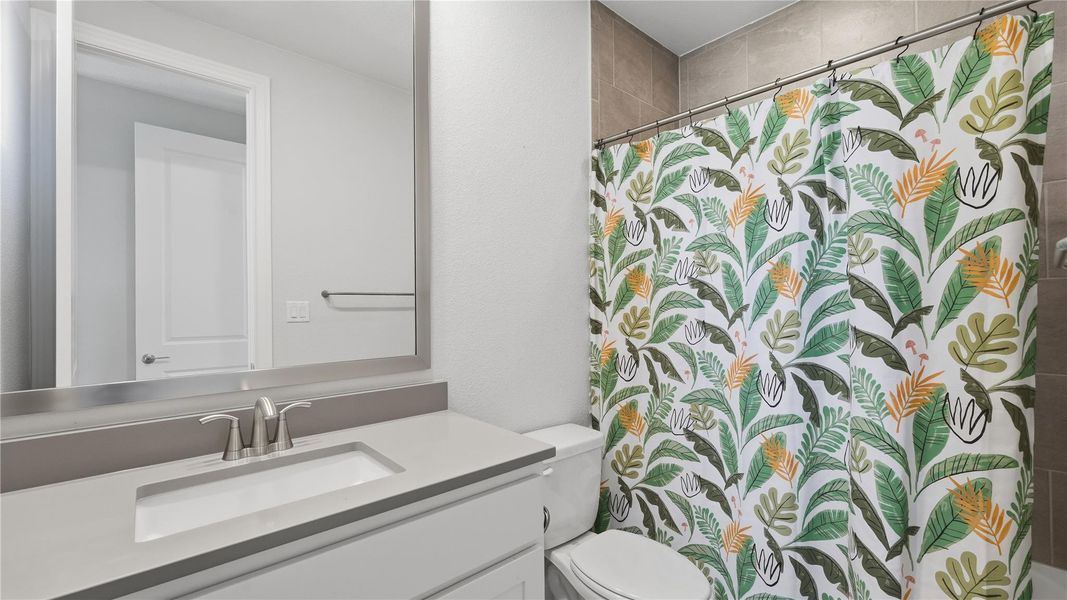 Full bath featuring curtained shower and vanity Full bath featuring curtained shower and vanity