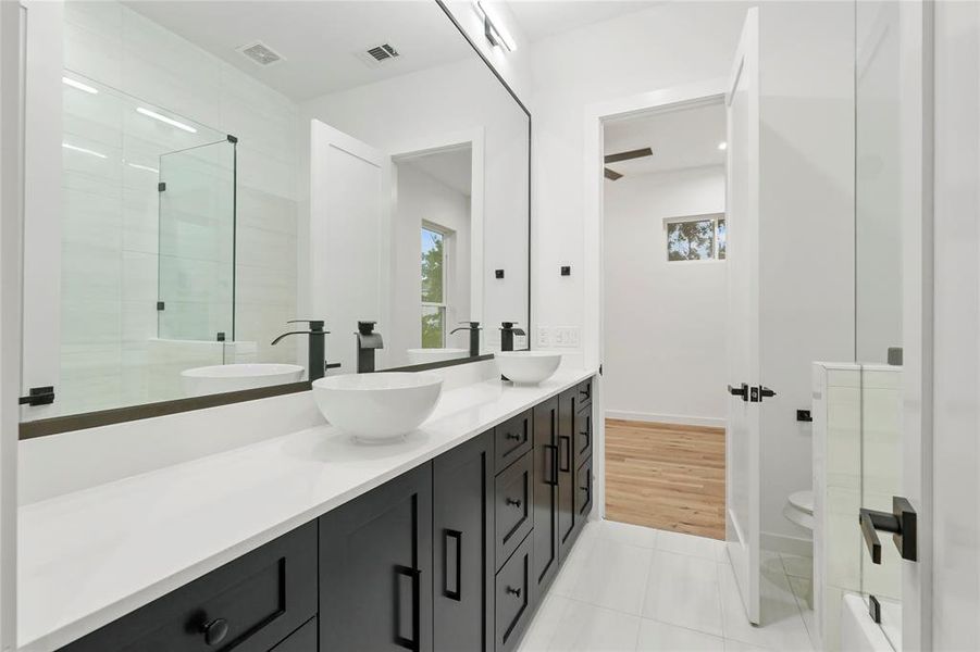 Bathroom featuring toilet, hardwood / wood-style floors, and double sink vanity