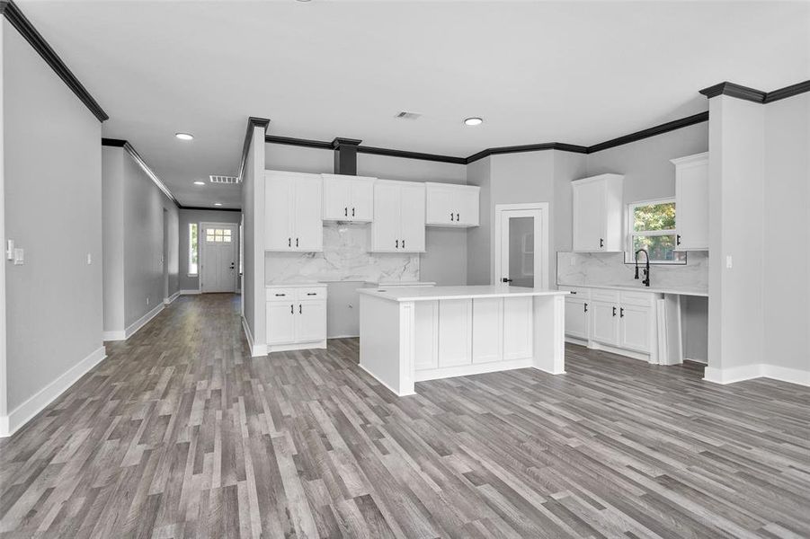 A full view of your kitchen from living area. Stove/oven, microwave and dishwasher will be added prior to closing. Notice the bar seating available at Island.