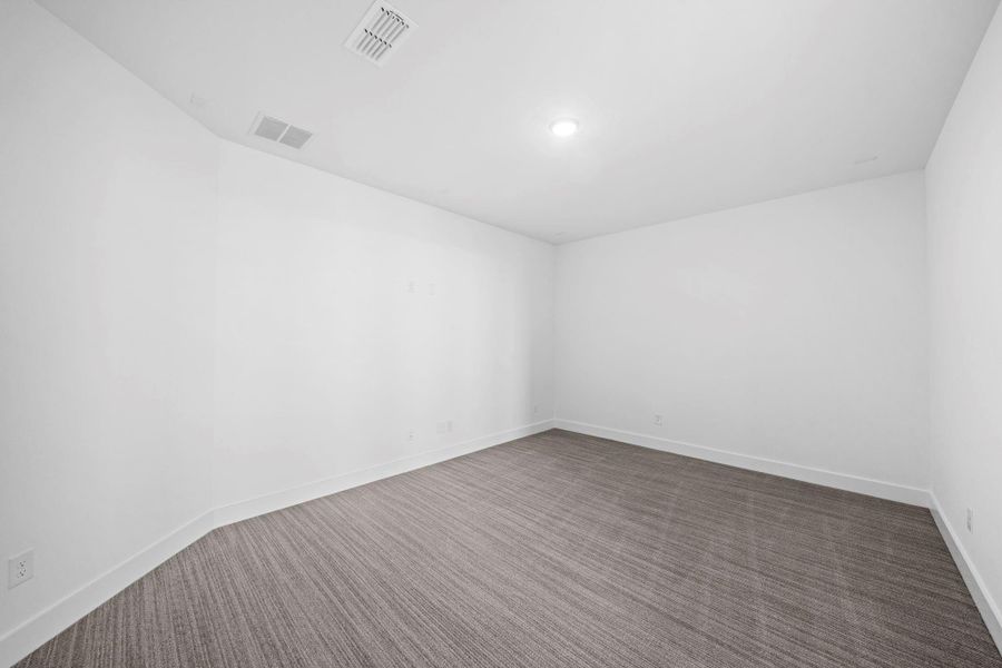 Spacious upstairs game room with open floor plan, high ceilings, and abundant natural light.