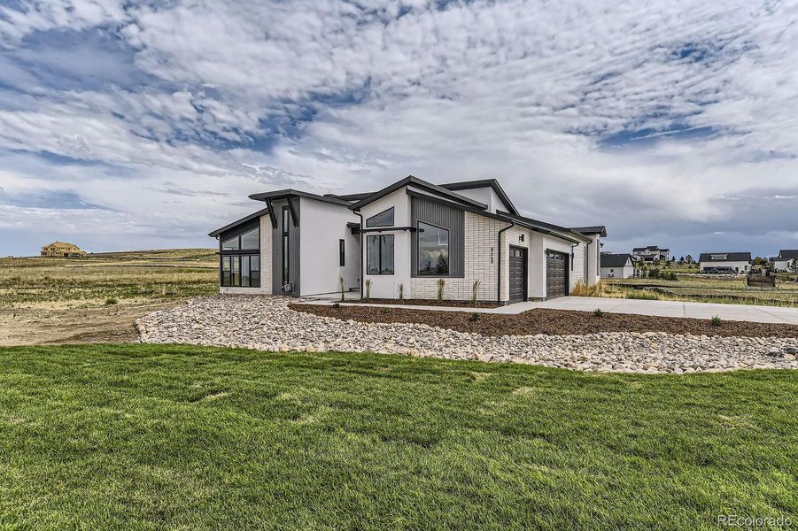 Front exterior of a new home in , Parker, CO, highlighting curb appeal (Image 24).