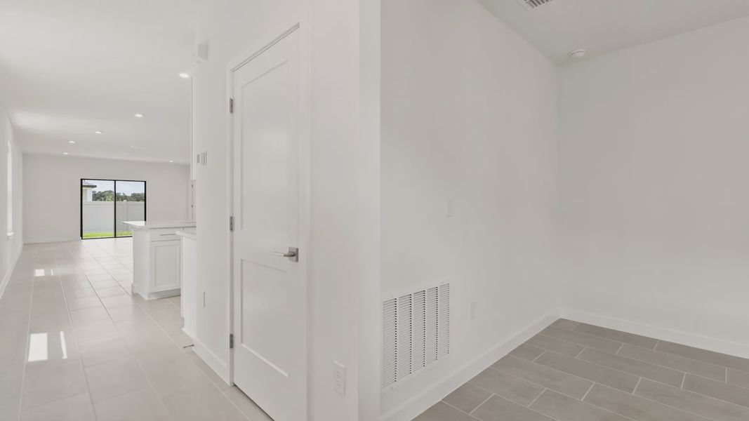 The Flagler Floorplan at Grasslands West new home in Lakeland, FL Showcasing a bright Kitchen & Entryway.