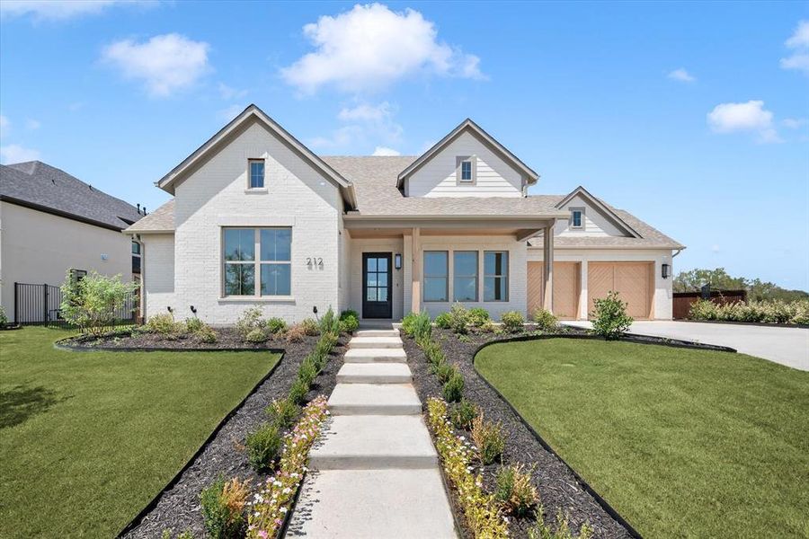 View of front of home featuring a garage and a front yard