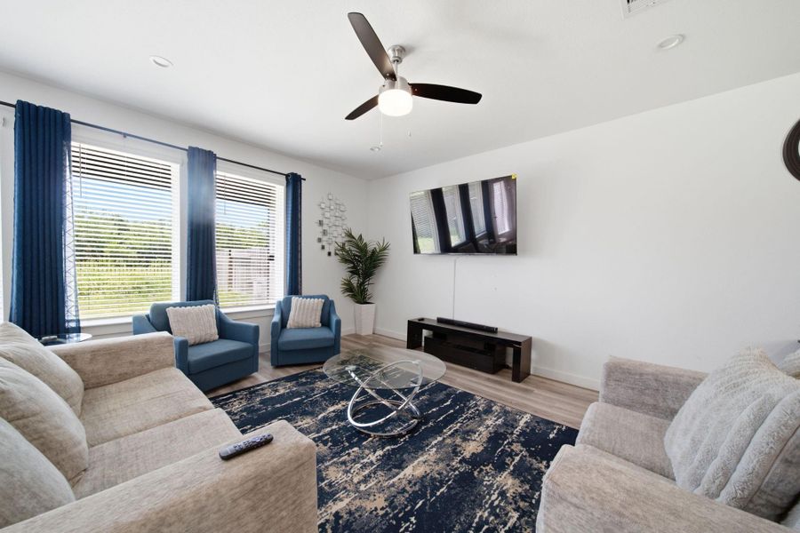 Natural light fills the open-concept living room, creating a warm, bright, and inviting space perfect for relaxing and entertaining.