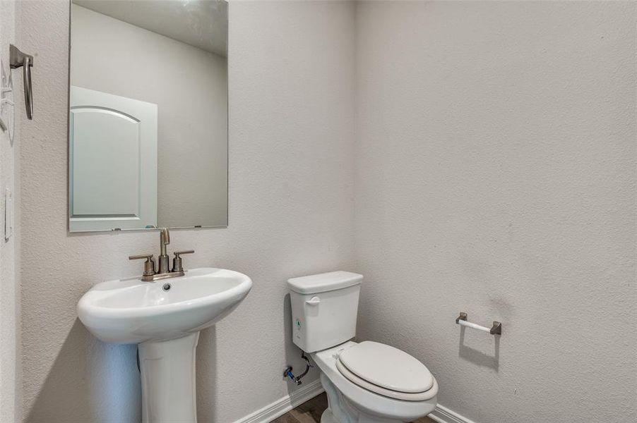 Half bathroom with a textured wall