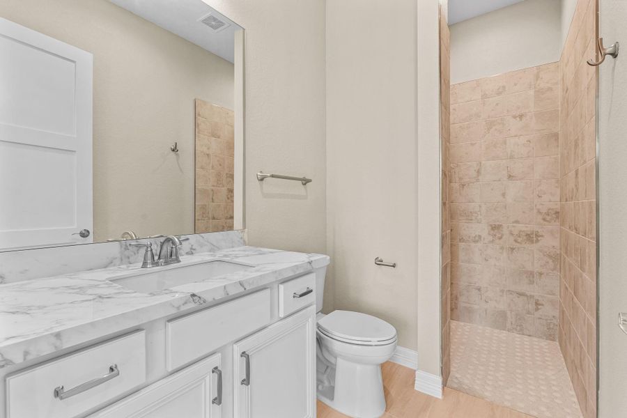 Close-up view highlighting the ensuite access from the office/guest suite, featuring modern fixtures and seamless connection to the private bath.