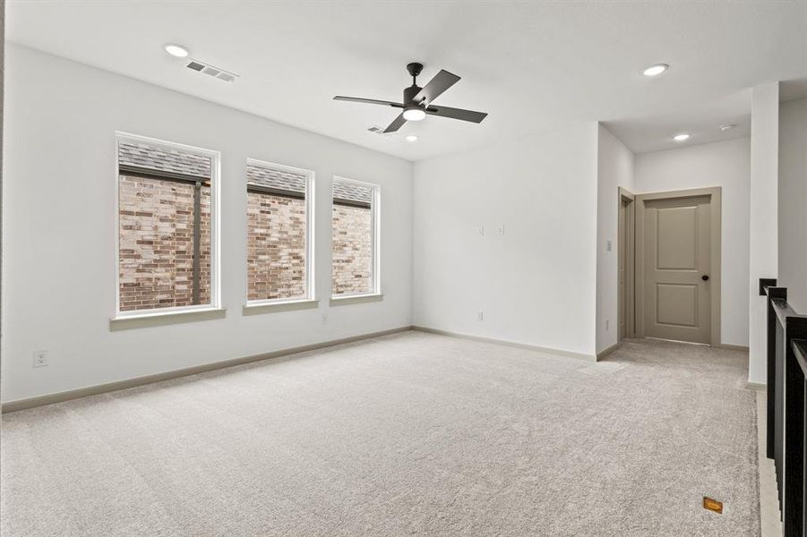 Unfurnished living room with light colored carpet, recessed lighting, and a ceiling fan