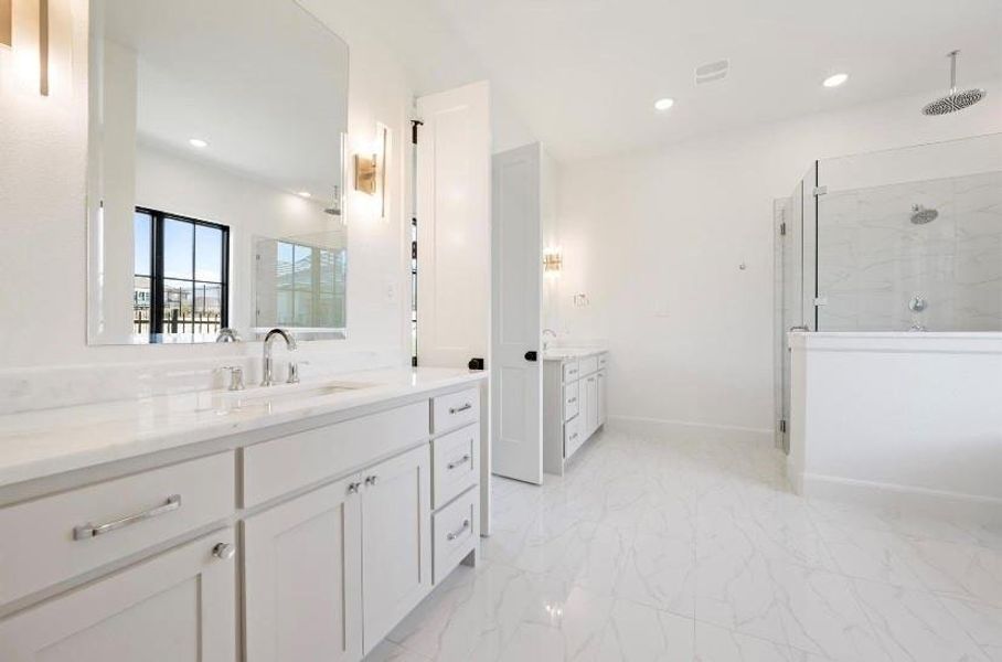 Bathroom featuring vanity and a shower with shower door