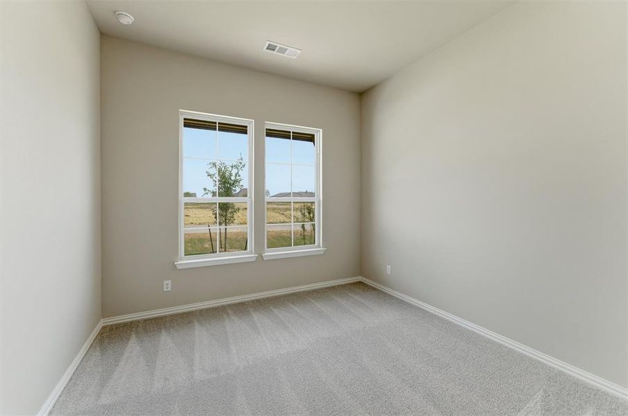 Unfurnished room with light carpet and baseboards Unfurnished room with light carpet and baseboards