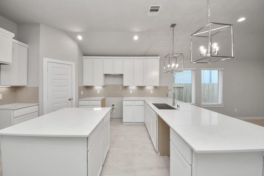 The open concept effortlessly connects the kitchen to the expansive family room, forming a perfect hub for gatherings. This seamless flow creates an inviting space where cooking and socializing come together harmoniously. Sample photo of completed home with similar floor plan. Actual colors and selections may vary.