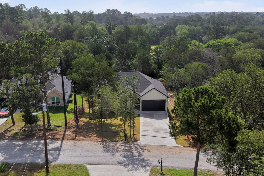 A private, verdant sanctuary awaits, nestled serenely amidst lush mature trees.