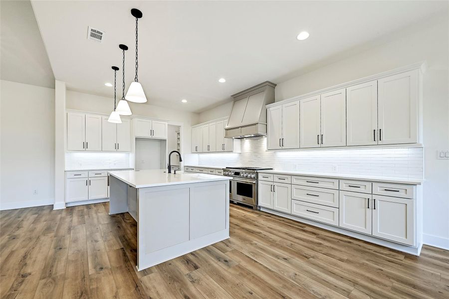 A perfect kitchen for entertaining and a huge pantry with coffee bar cabinetry.