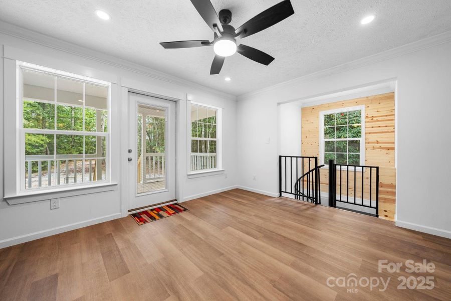 Living Area with great natural light and Spiral staircase leading to the full finished basement