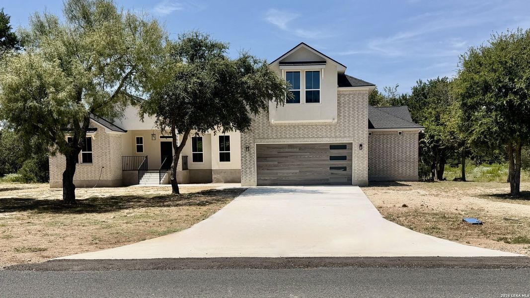 Front exterior of a new home in , Bulverde, TX, highlighting curb appeal (Image 25).