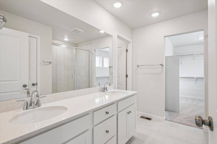 A bathroom with a large mirror. A bathroom with a large mirror.