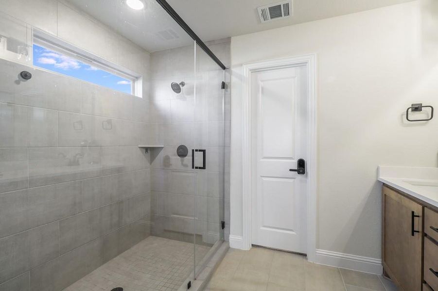 Bathroom featuring vanity and a stall shower