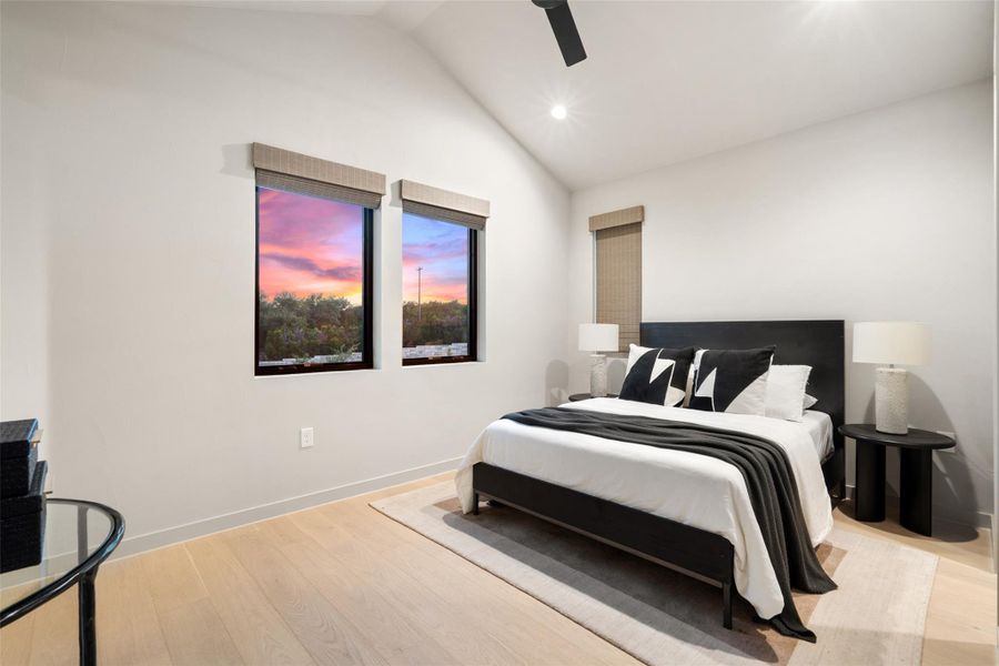 Slanted high ceilings and numerous windows fill this serene bedroom with natural light and scenic views. Slanted high ceilings and numerous windows fill this serene bedroom with natural light and scenic views.