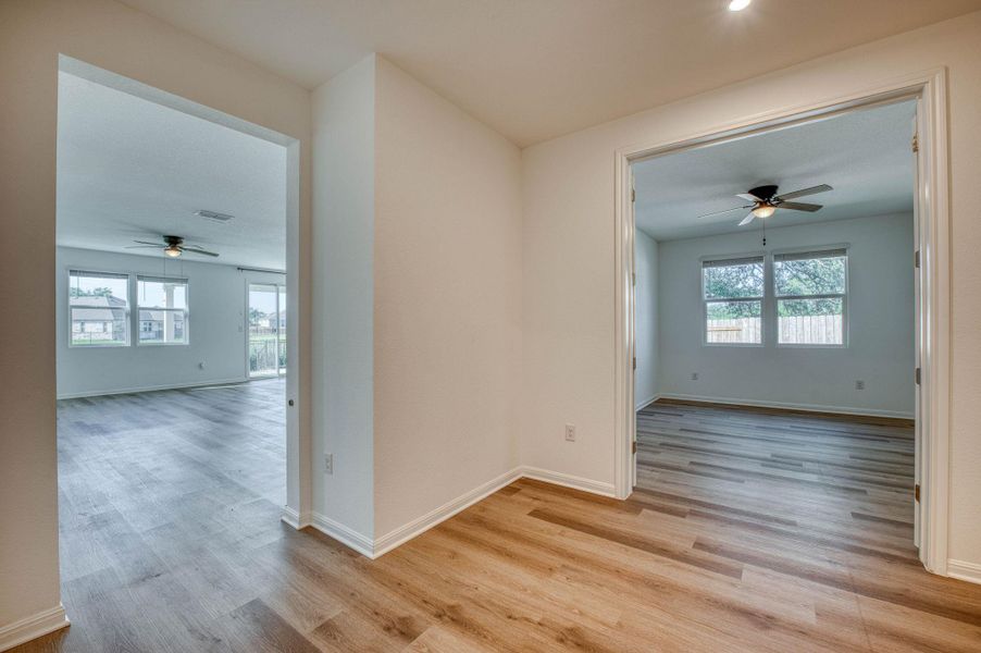 An open floorplan seamlessly connects the versatile interior spaces finished with durable wood-look flooring.
