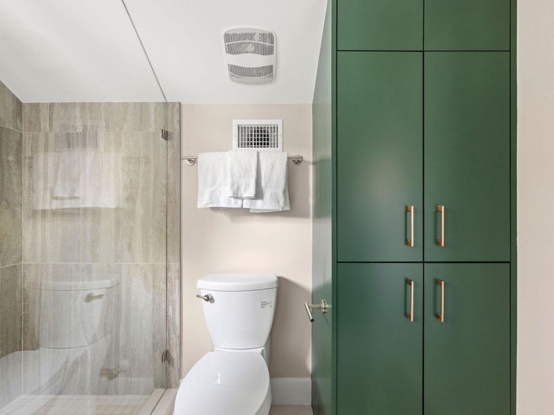 Full bathroom with a stall shower and toilet Full bathroom with a stall shower and toilet