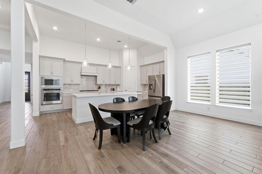 Open plan dining area overlooking kitchen and living room