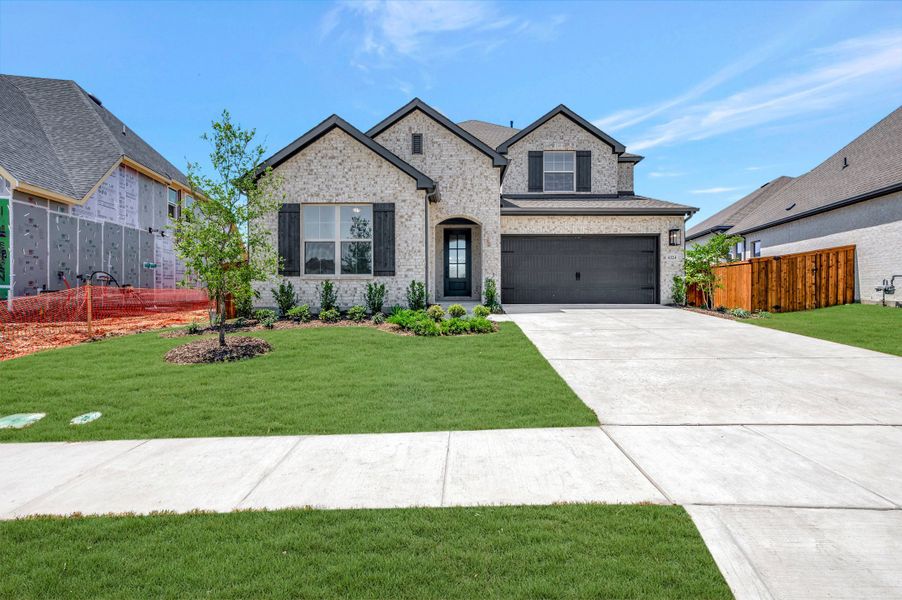 Front exterior of a new home in Sandbrock Ranch, Aubrey, TX, highlighting curb appeal (Image 1). Front exterior of a new home in Sandbrock Ranch, Aubrey, TX, highlighting curb appeal (Image 1).