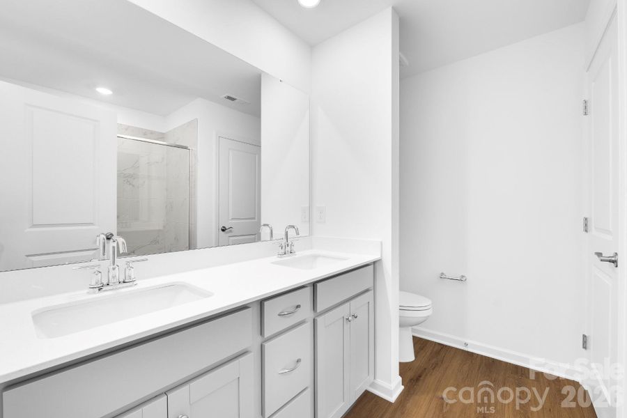 primary bathroom with double bowl vanity and tile shower primary bathroom with double bowl vanity and tile shower