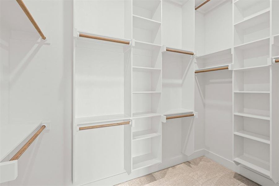 Spacious closet with light colored carpet