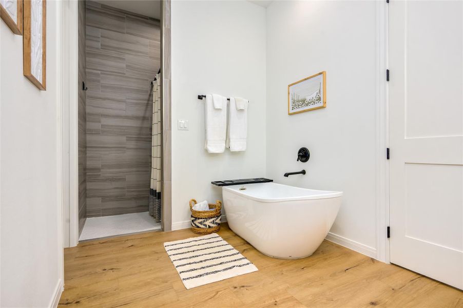 Primary bathroom features two separate vanities, free standing tub and separate shower and large closet.