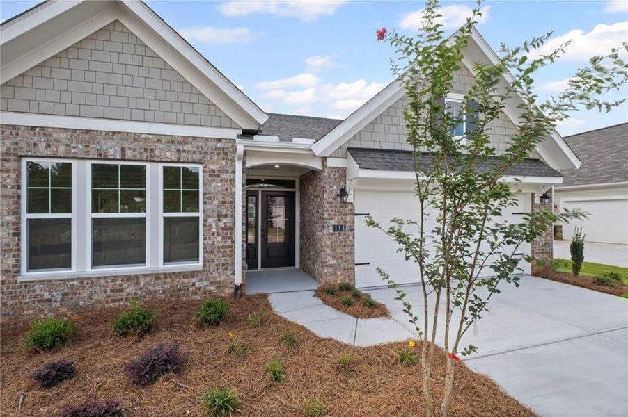 Front exterior of a new home in Laurel Farms, Dallas, GA, highlighting curb appeal (Image 20). Front exterior of a new home in Laurel Farms, Dallas, GA, highlighting curb appeal (Image 20).