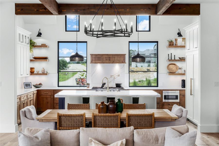 Bar with beamed ceiling, sink, and light hardwood / wood-style flooring