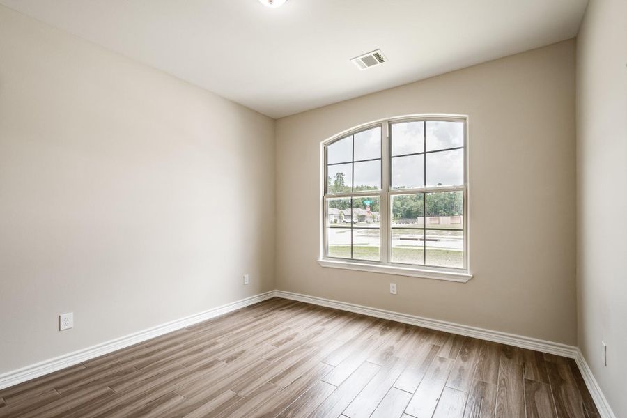 Sunny front-facing bedroom with large window. Sunny front-facing bedroom with large window.
