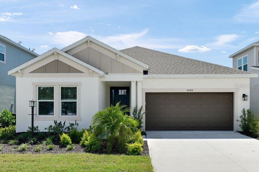Front exterior of a new home in Tiburon, Nokomis, FL, highlighting curb appeal (Image 1).