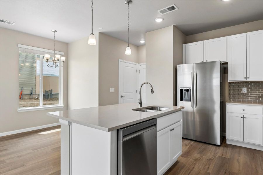 A kitchen with white cabinets.