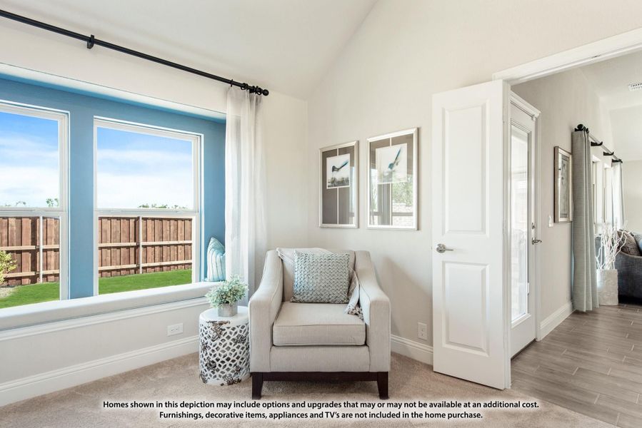Bedroom sitting area with accent chair, large windows, vaulted ceiling, and carpet flooring Bedroom sitting area with accent chair, large windows, vaulted ceiling, and carpet flooring